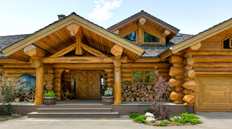 Handcrafted log home with a timber porch and stacked log corners